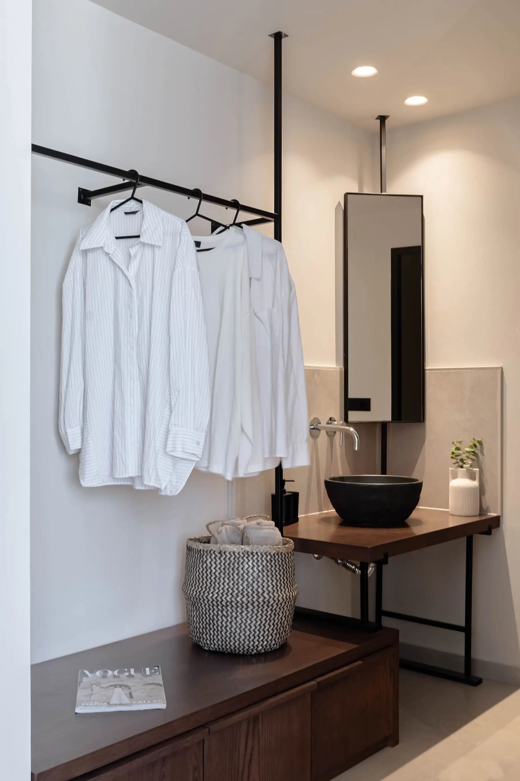 Bathroom vanity and wardrobe with hanging shirts