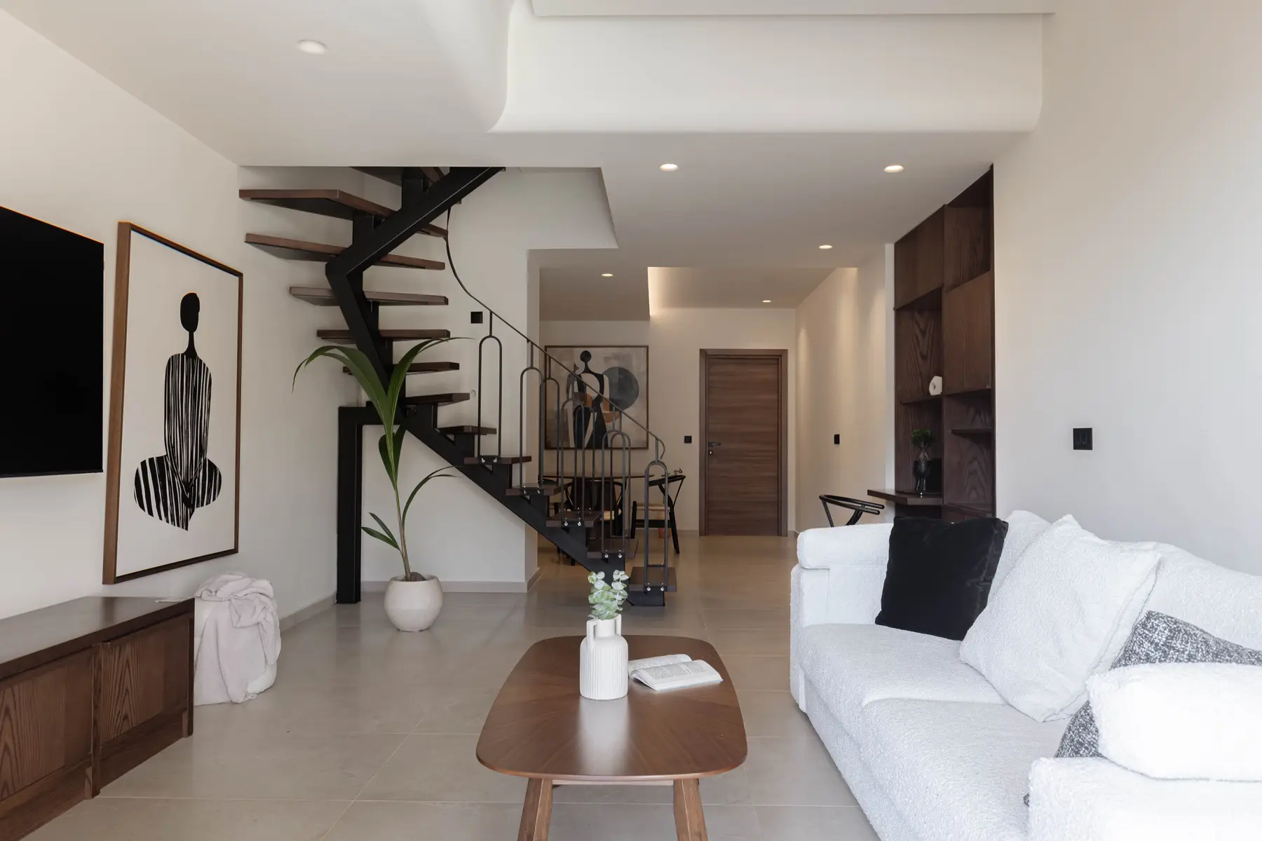 Living room of the Two-Bedroom Suite beneath the black steel staircase