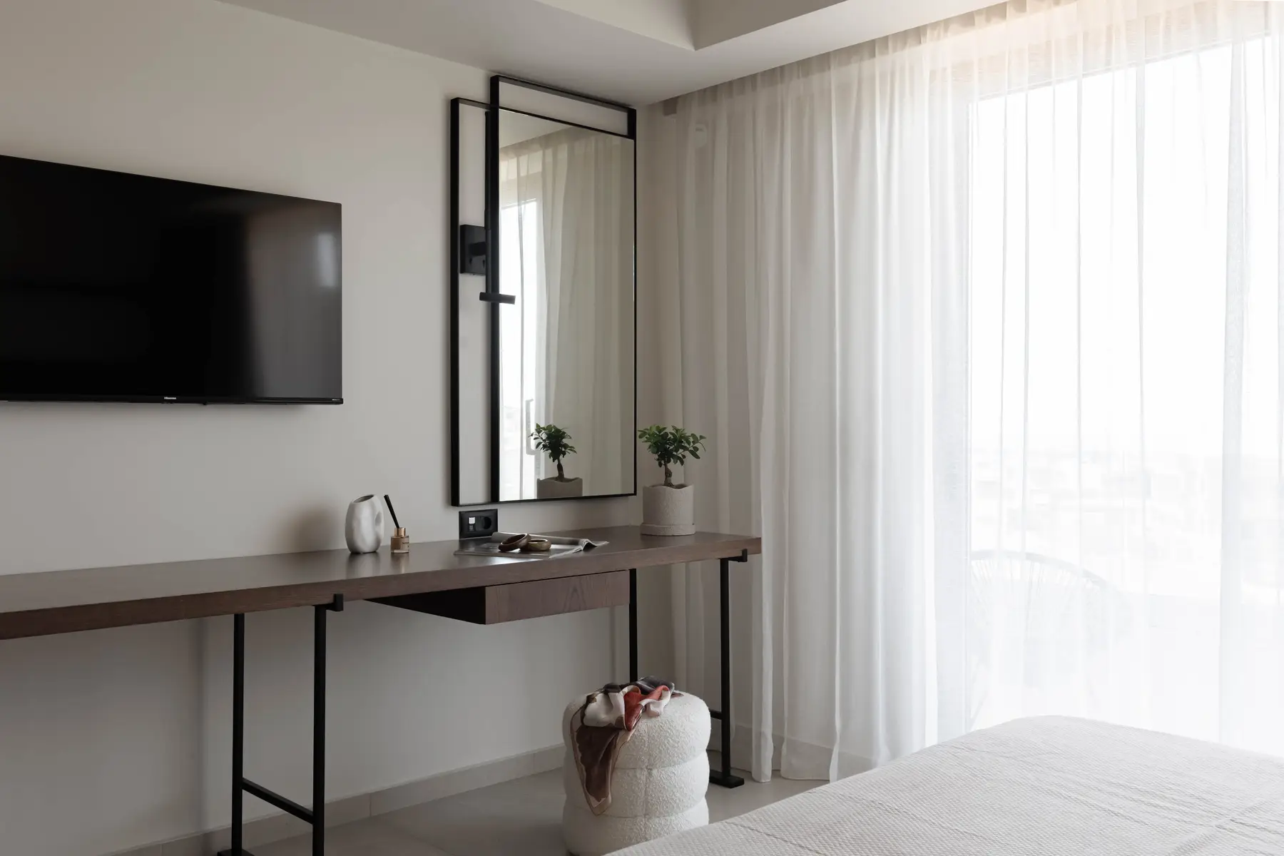 Dressing table and mirror beside the balcony door