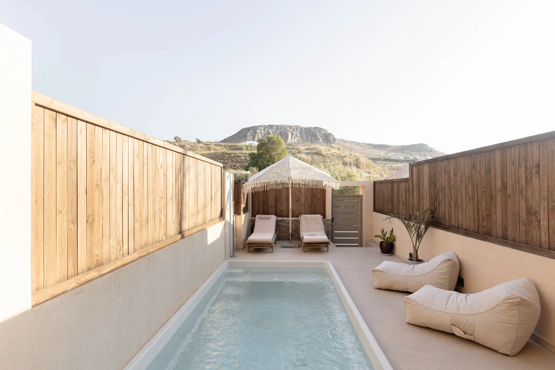 Private pool and macramé umbrella in the walled courtyard